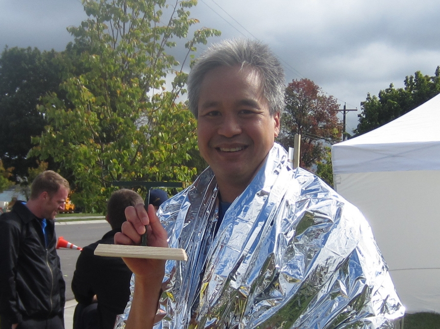 Nick Jesdanun holding his marathon trophy